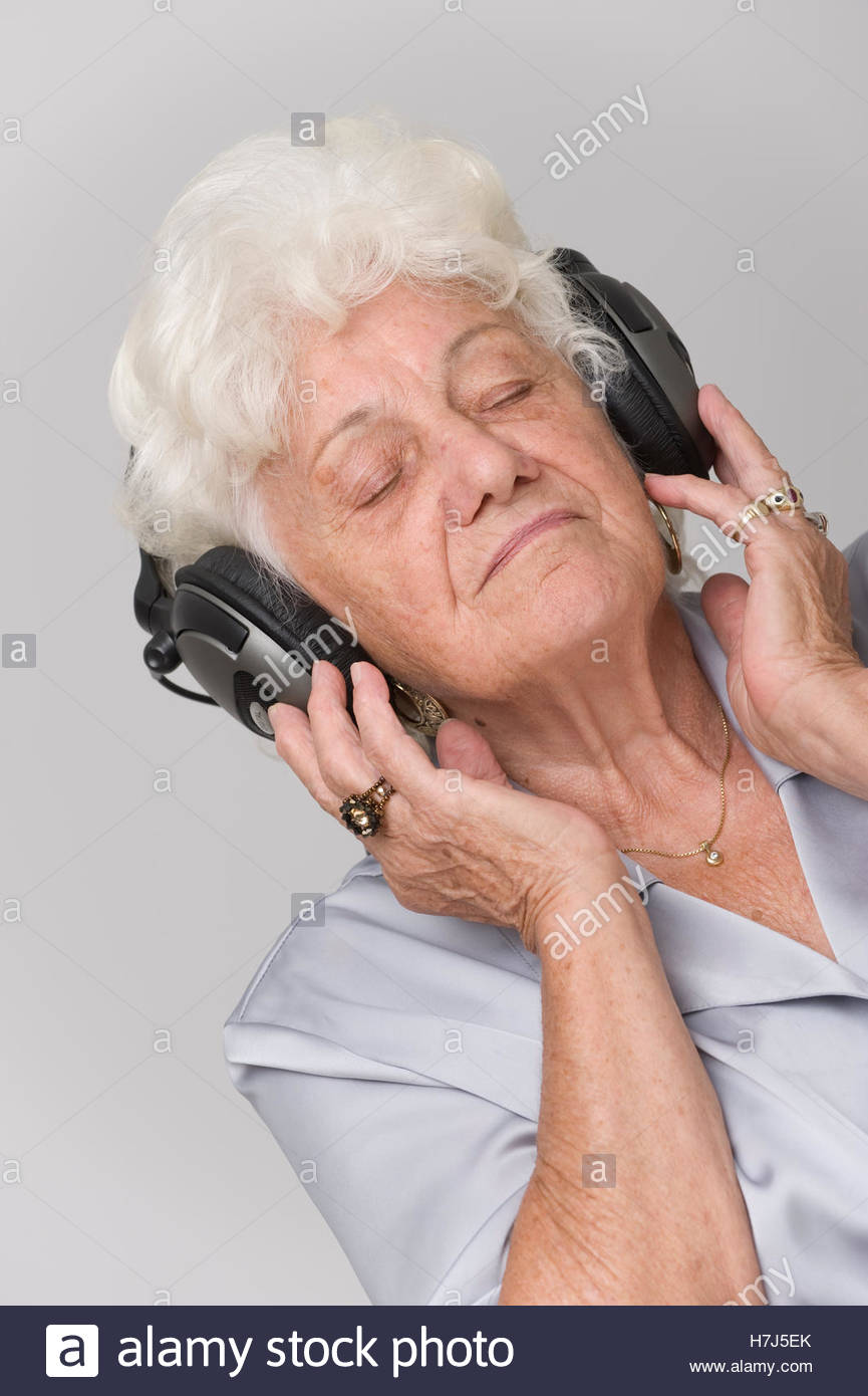 elderly-woman-wearing-headphones-while-listening-to-music-H7J5EK.jpg